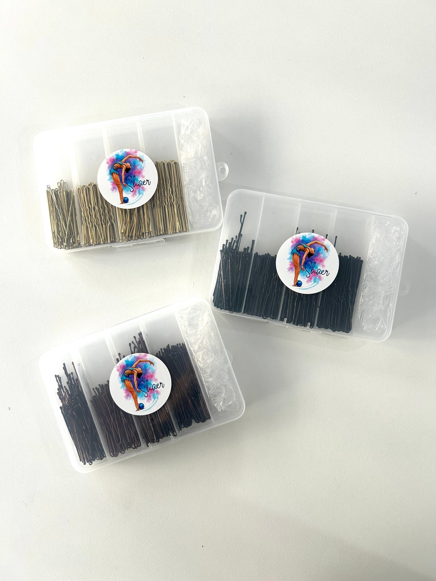 Caja de horquillas variadas y gomas. 300 uds. - marrón, negro o dorado